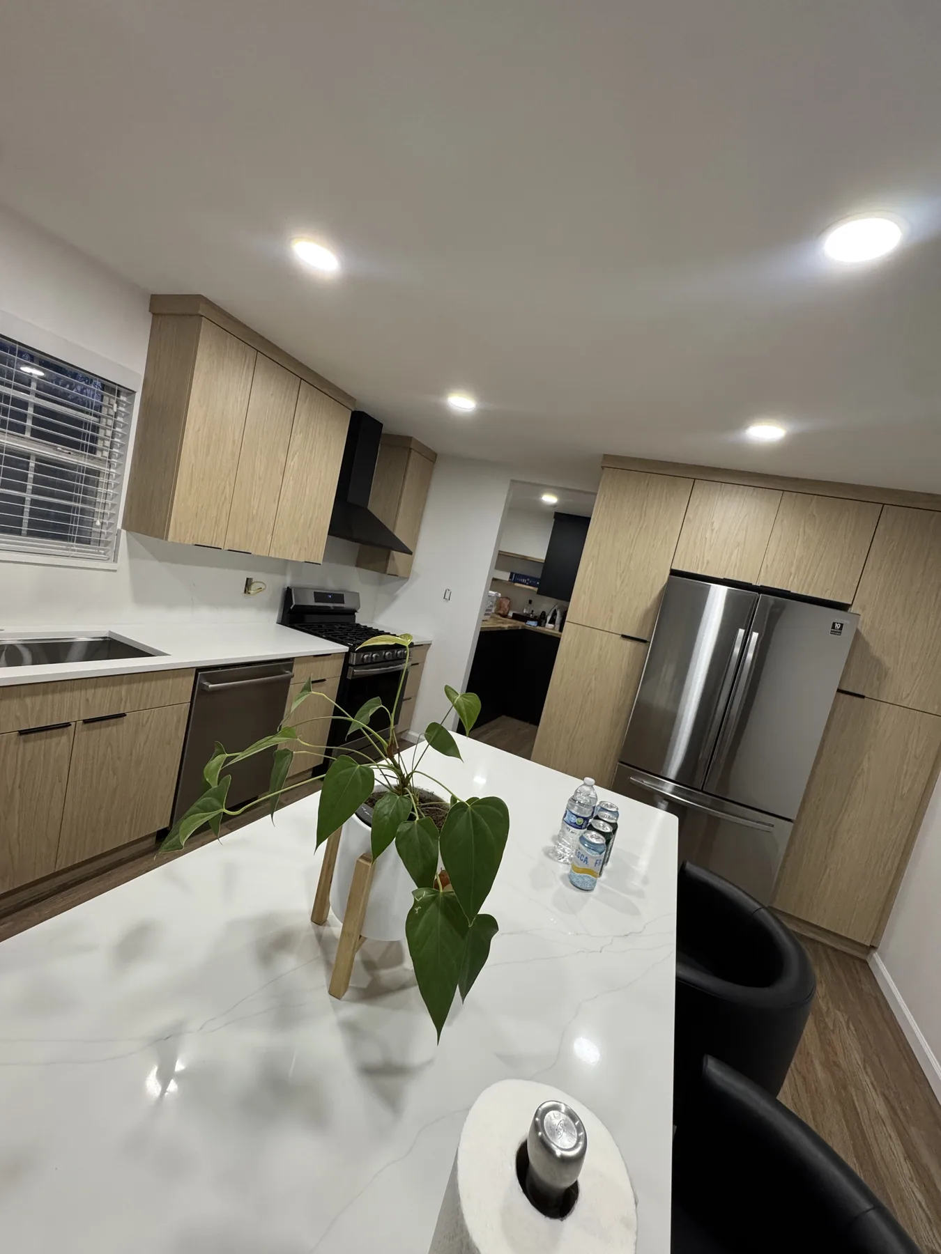 Close view of a white kitchen island countertop in a natural wood kitchen